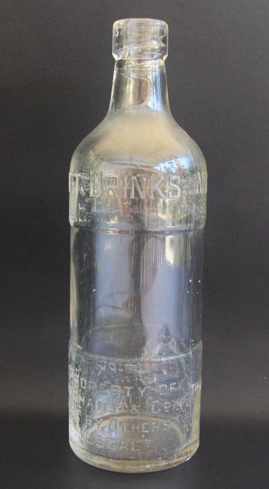 Glass bottle with black screw-in stopper with rubber seal. Stamped with “The Property of Marchant & Co. It’s use by other is illegal” and “Trade mark regd. Australia”.