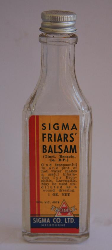 Glass flat bottle with neck.  Metal screw lid. Number 102. Orange/red label on front.