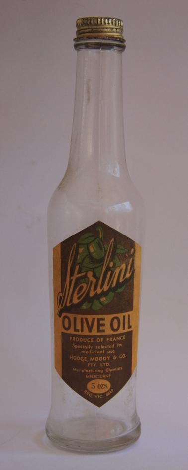 5oz Glass bottle with metal lid. Coloured label on front of bottle. Stamp on bottom of bottle “F594”.