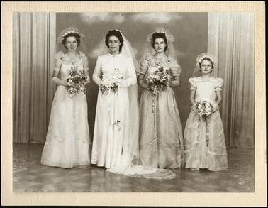 A wedding photo of a bride in wedding dress with three bridesmaids
