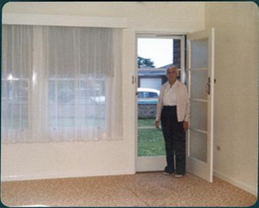 The photo is of Ivy Young standing in doorway of a Vancouver Street home