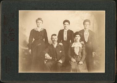 A family group photo of four ladies and one gentleman