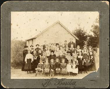 Rev McDougall?, or Mr. Olley ,adults and children photographed in front of the Wesleyan Chapel     