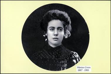 This is a studio photograph  and shows a dark haired attractive woman in period dress. She is wearing a dark dress with a smocking effect at the top. 