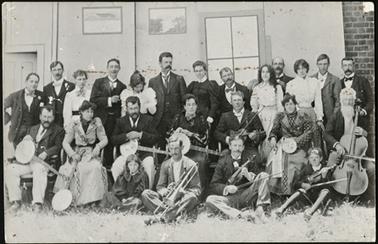 An Orchestra group photo of adults and children of various ages