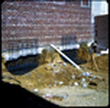 This shows a red brick wall and some blue metal grids that look to be supporting the wall in some way.  