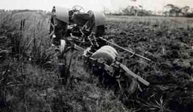 Disc Plough stationary in partially ploughed paddock.