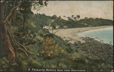 This is a coloured postcard showing a beach with beach huts. There is a steep embankment sweeping down to the beach. The sea is on the right of the picture.